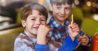 Young boy eating chips