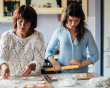 Mother and her teenage daughter baking together